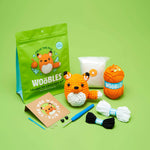 Crochet kit with fox, yarn, and accessories.