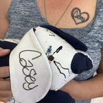 Woman holding a dog-shaped plush toy.
