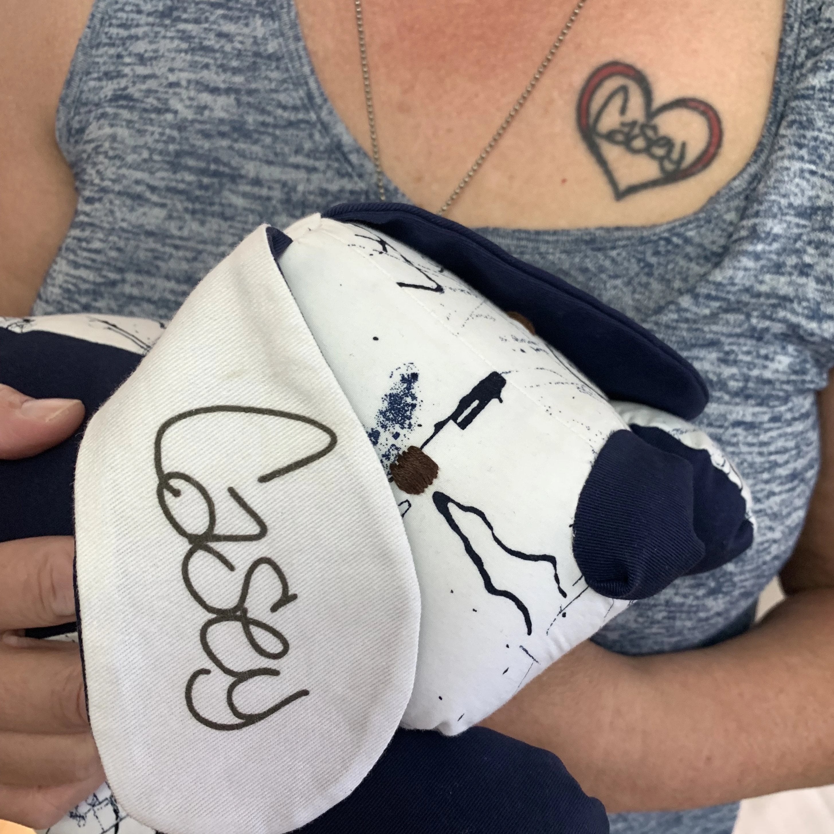 Woman holding a dog-shaped plush toy.