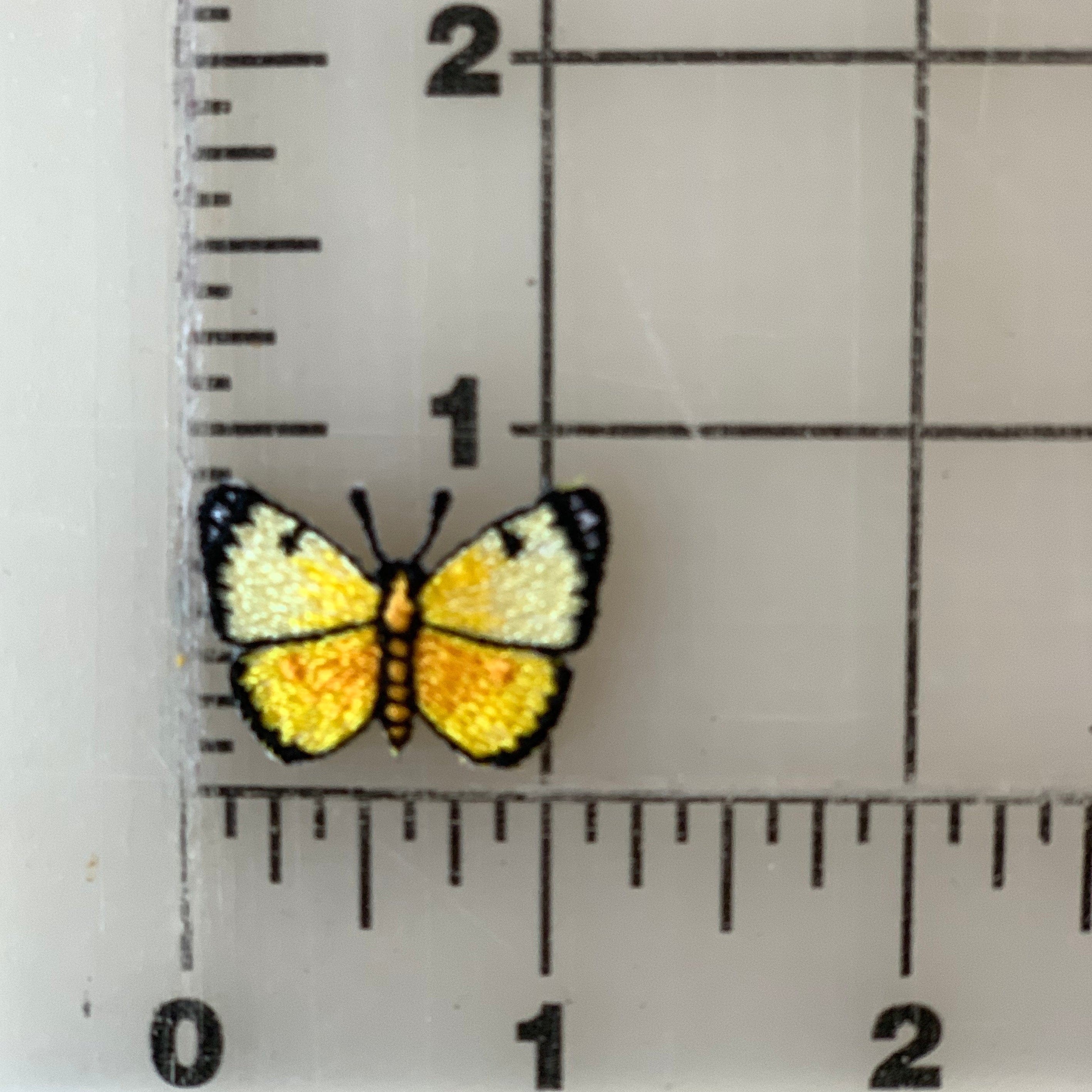 Yellow butterfly patch next to a ruler.