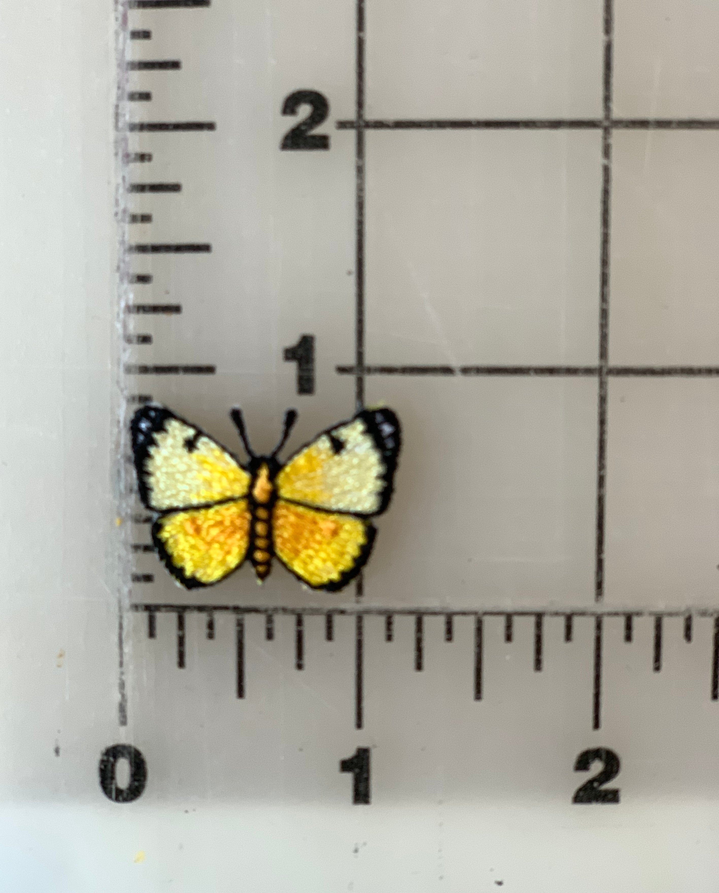 Yellow butterfly patch next to a ruler.
