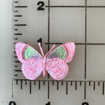 Pink butterfly patch on a ruler.