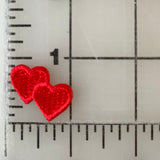 Two small red heart shapes on a ruler.