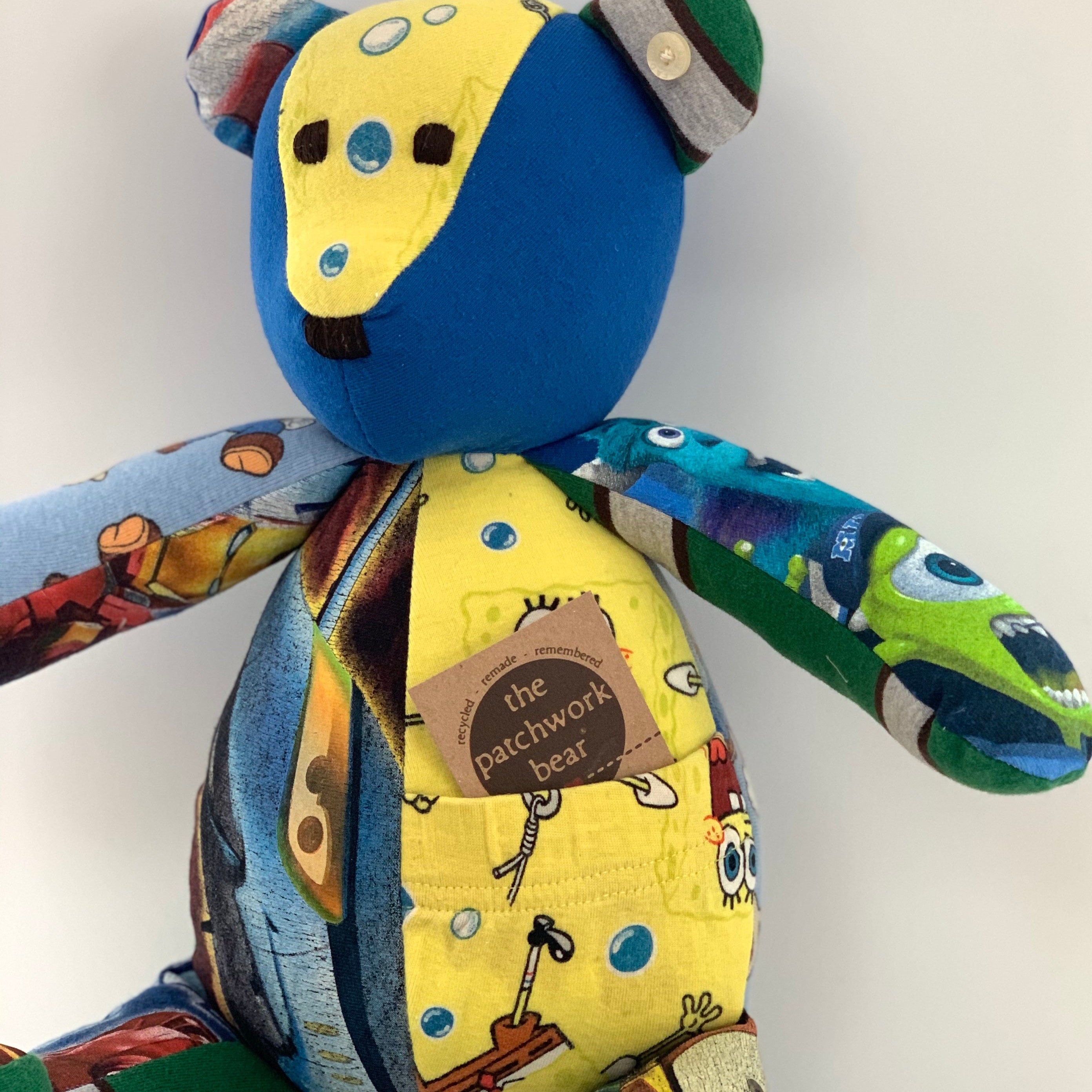 Patchwork teddy bear with a yellow pocket.