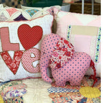 Patchwork elephant with LOVE pillows and red Liberty fabric.