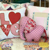 Patchwork elephant with LOVE pillows and red Liberty fabric.