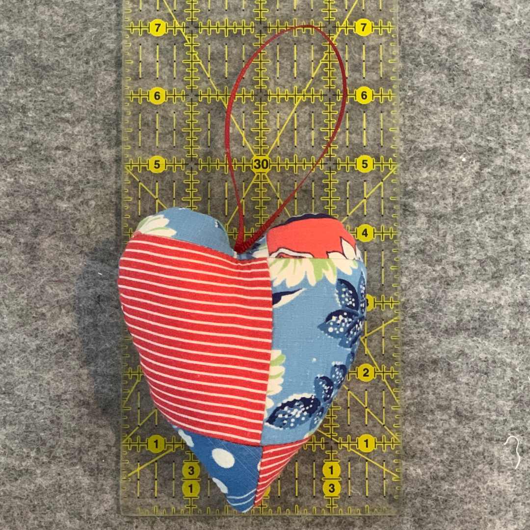 Patchwork heart ornament with ruler for size comparison