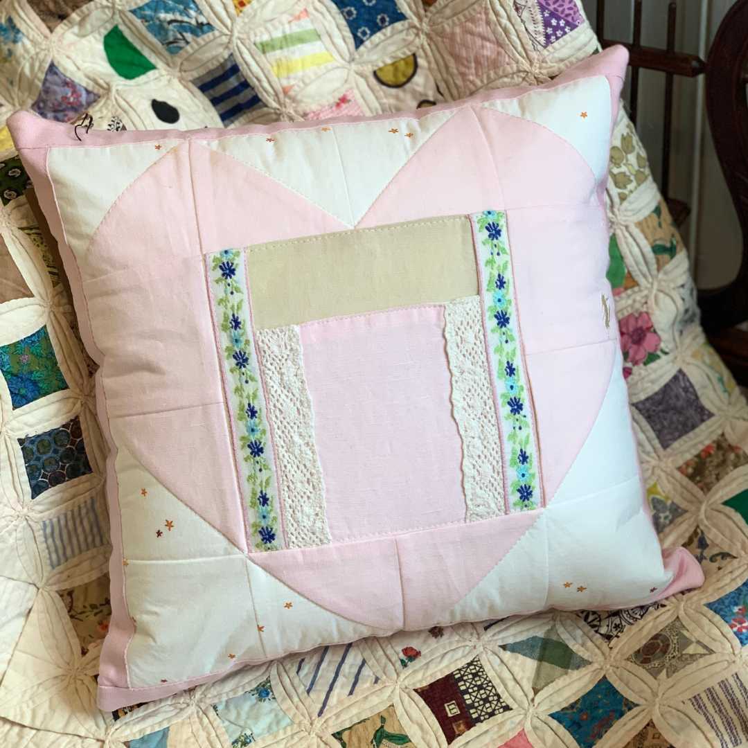 Pink quilted heart pillow with lace