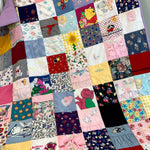 Barney quilt made from various fabrics and squares