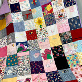 Barney quilt made from various fabrics and squares