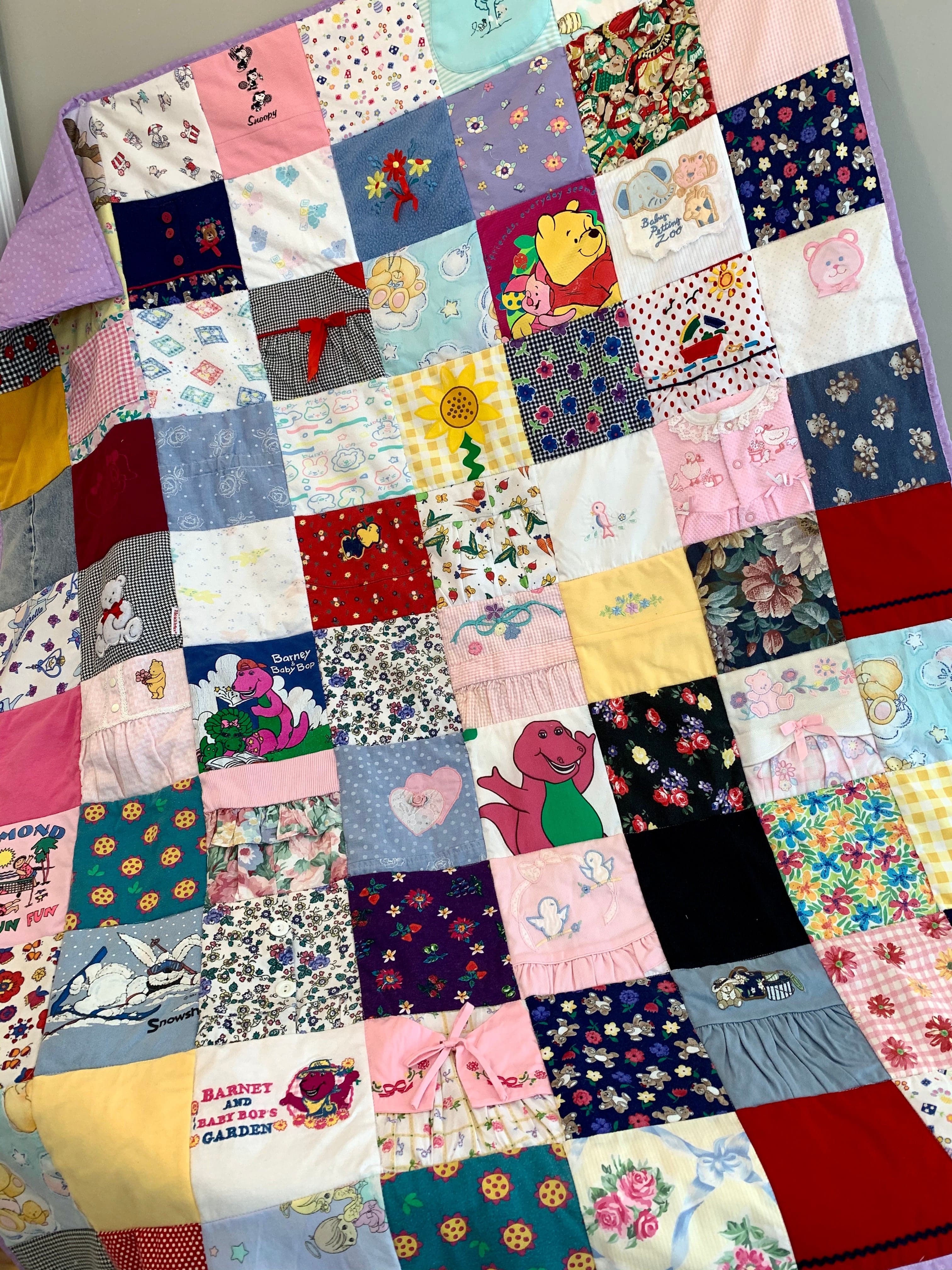 Barney quilt made of colorful fabric squares.