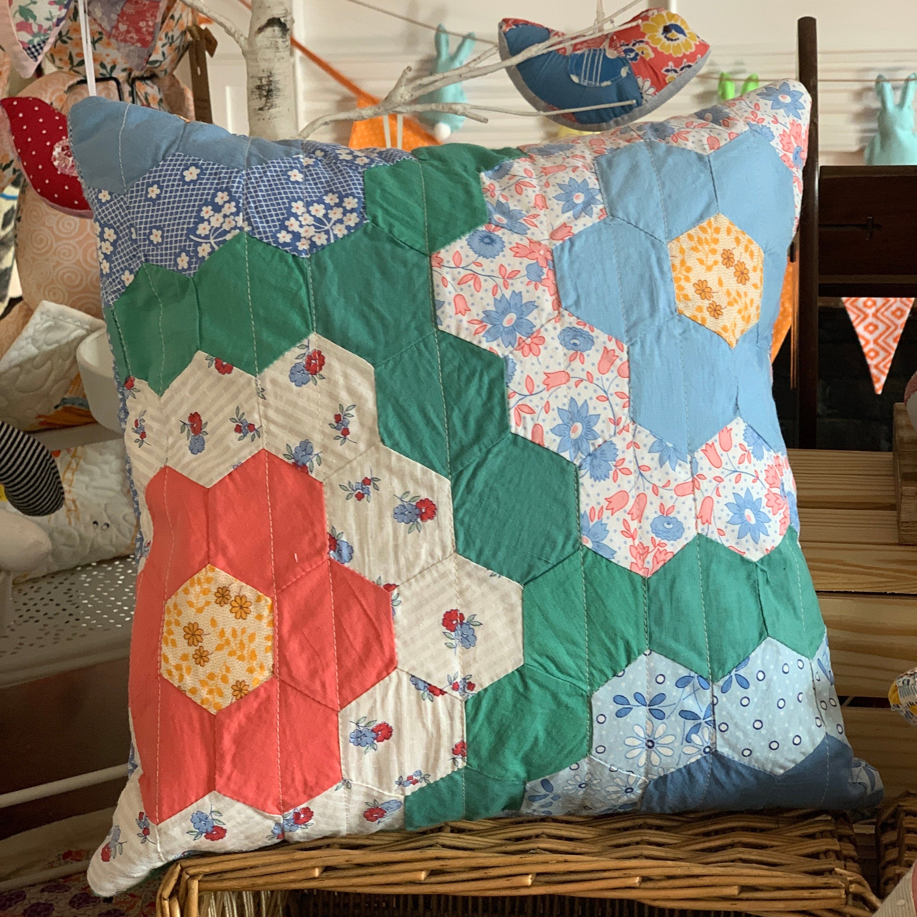 Grandmother's flower garden pillow with colorful flower quilt design.