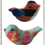 Memory bird plushies with floral and patterned designs.