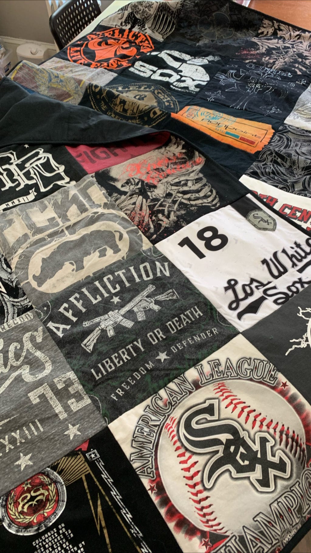 T-shirt quilt made from various band & sports shirts.